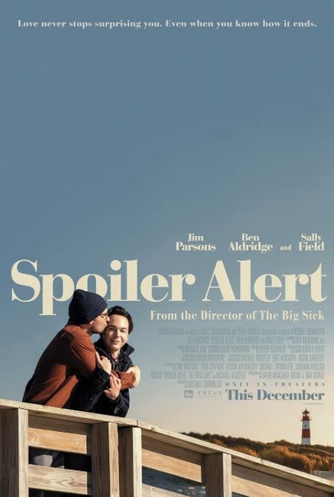 Two men embrace next to a railing at the seaside with a lighthouse in the far background. Poster for the movie "Spoiler Alert."
