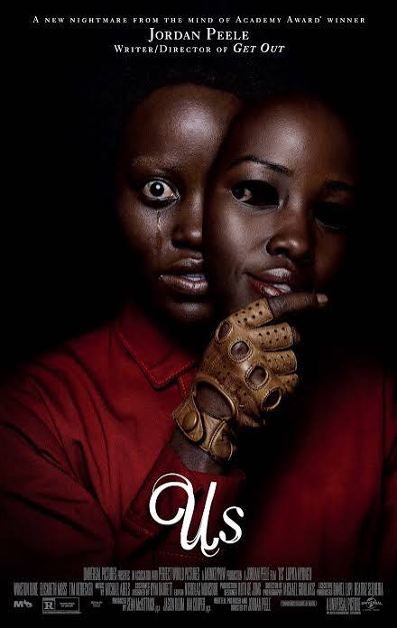 Movie Poster for "Us". Lupita Nyong'o dressed in red, holds a mask of her face partly in front of her own face, while making an eerie expression