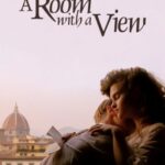 Movie poster for "A Room With A View." A young man and woman sit in the frame of an open window with a view of Florence, Italy in the background. The man has his face buried in the woman's neck as she reads a letter.