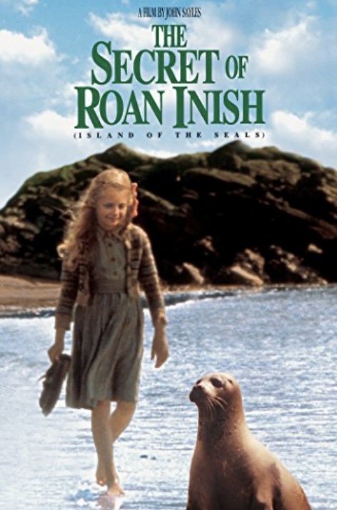 Poster for "The Secret of Roan Inish." A young girl in mid-20th century clothing, walks in the water on the shore of the sea. A seal stands right in front of her.